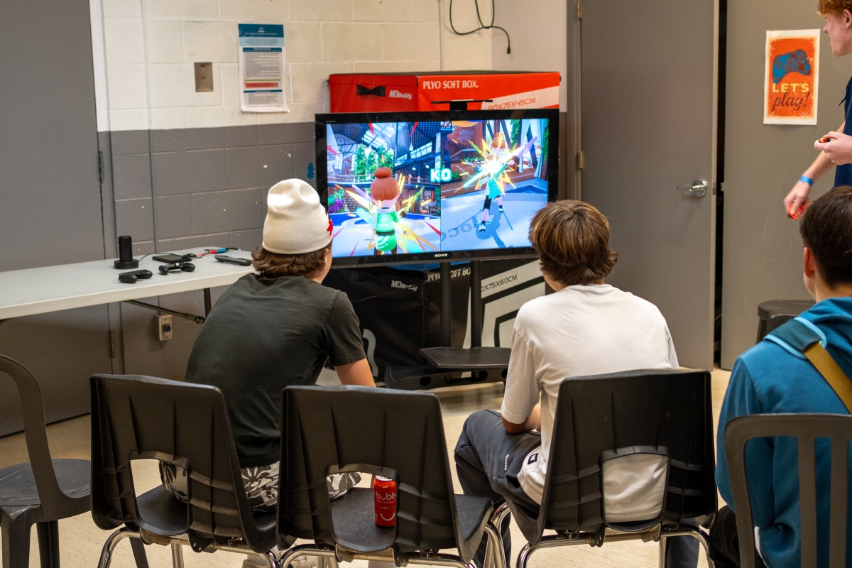 Two youth play video games at Youth Night in Winskill