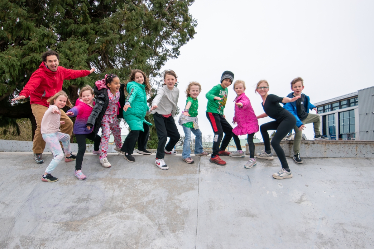 A group of summer campers excitedly pose for the camera.